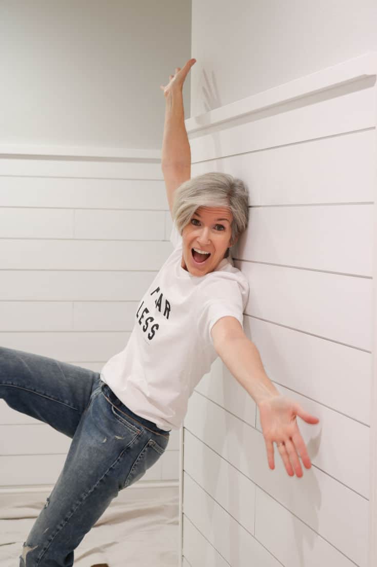 shiplap walls with woman posing in front