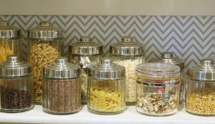 organized food containers sitting on shelf in pantry