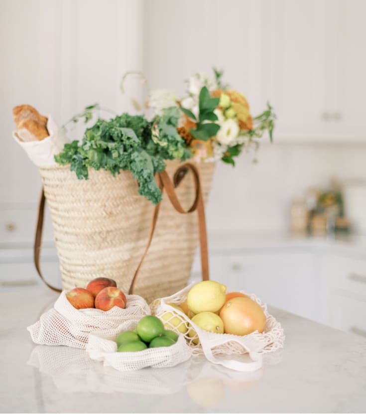 healthy natural bag full of groceries on a white kitchen counter