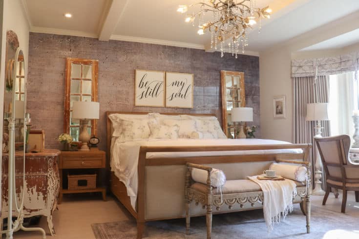 stunning sleigh bed in master bedroom with chandelier above