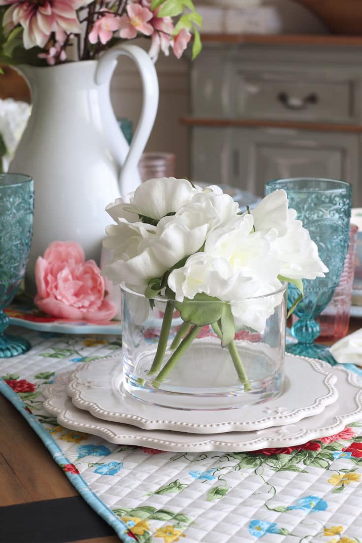 close up of white flowers in vase on dining table