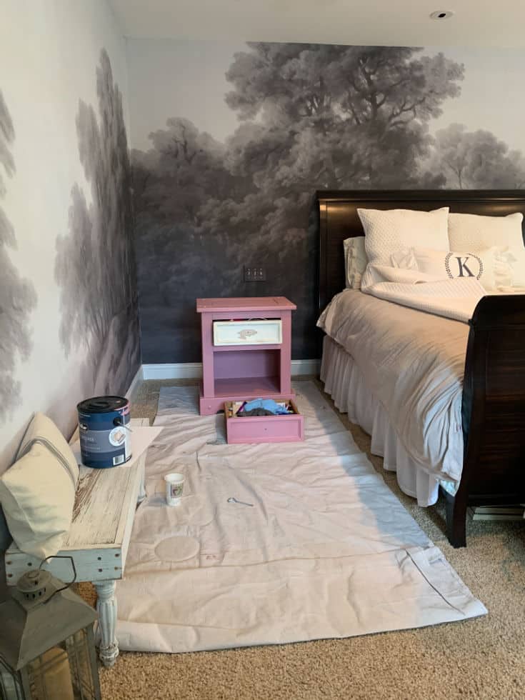bright pink paint side tables against gray mural