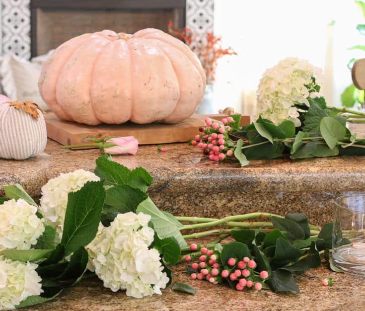 supplies you need for seasonal pumpkin vase centerpiece include cut flowers