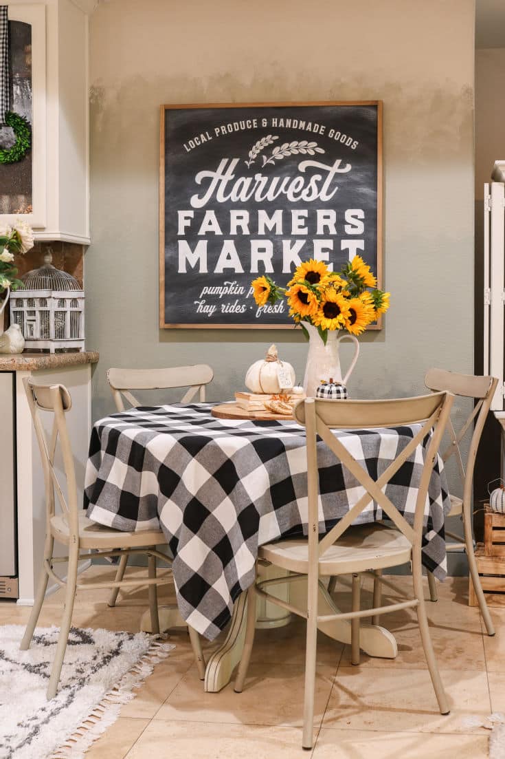 buffalo plaid cafe table pops with sunflowers and farmhouse market sign