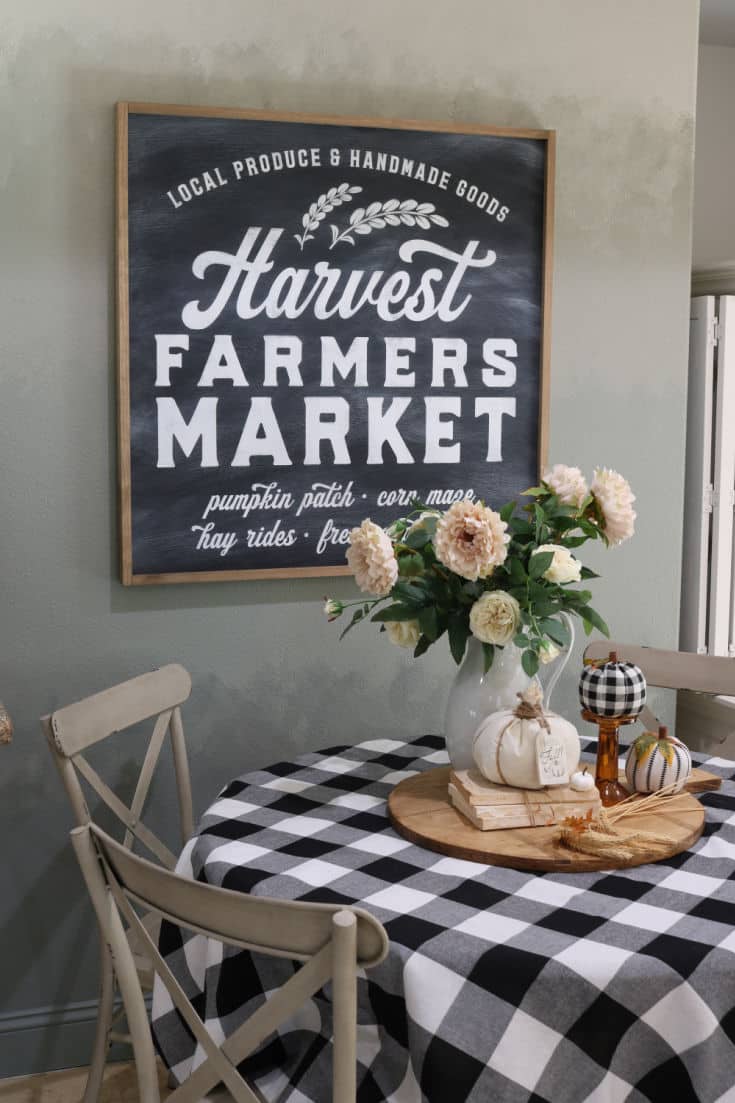 neutral farmhouse decor pops with black and white buffalo plaid tablecloth