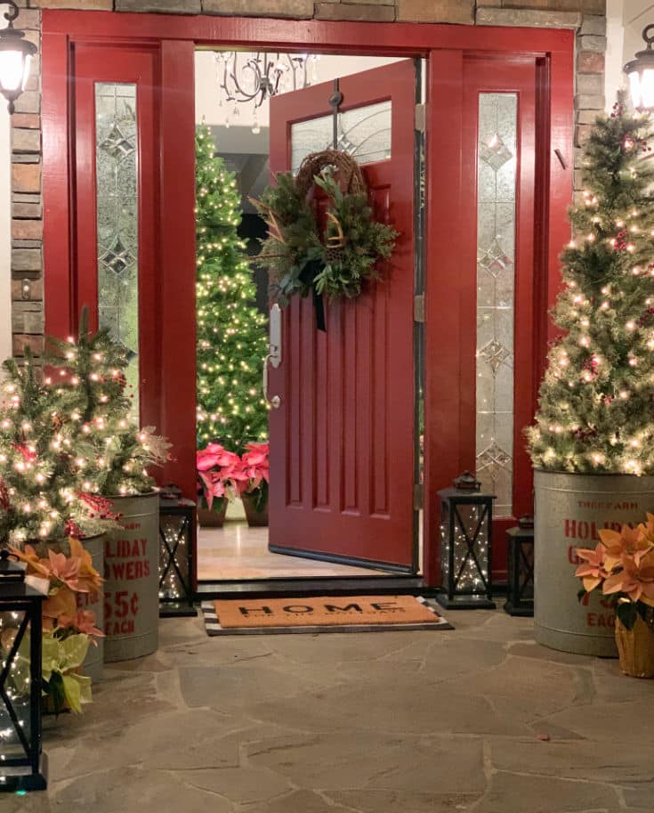 Christmas porch decor with mini Christmas trees and festive Christmas lights