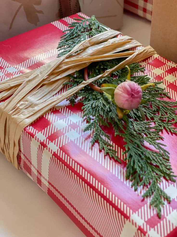 Plaid Christmas wrapping paper with raffia ribbon is festive and pretty