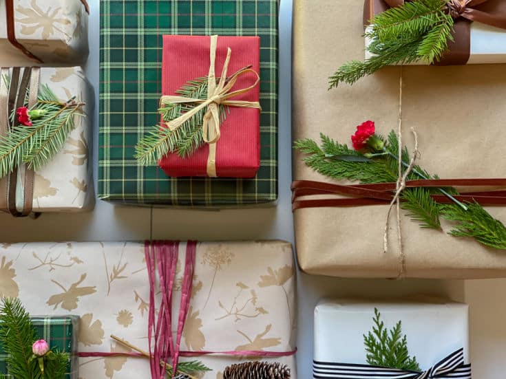 simple evergreen sprigs and floral buds adds personal touch to Christmas gift wrap