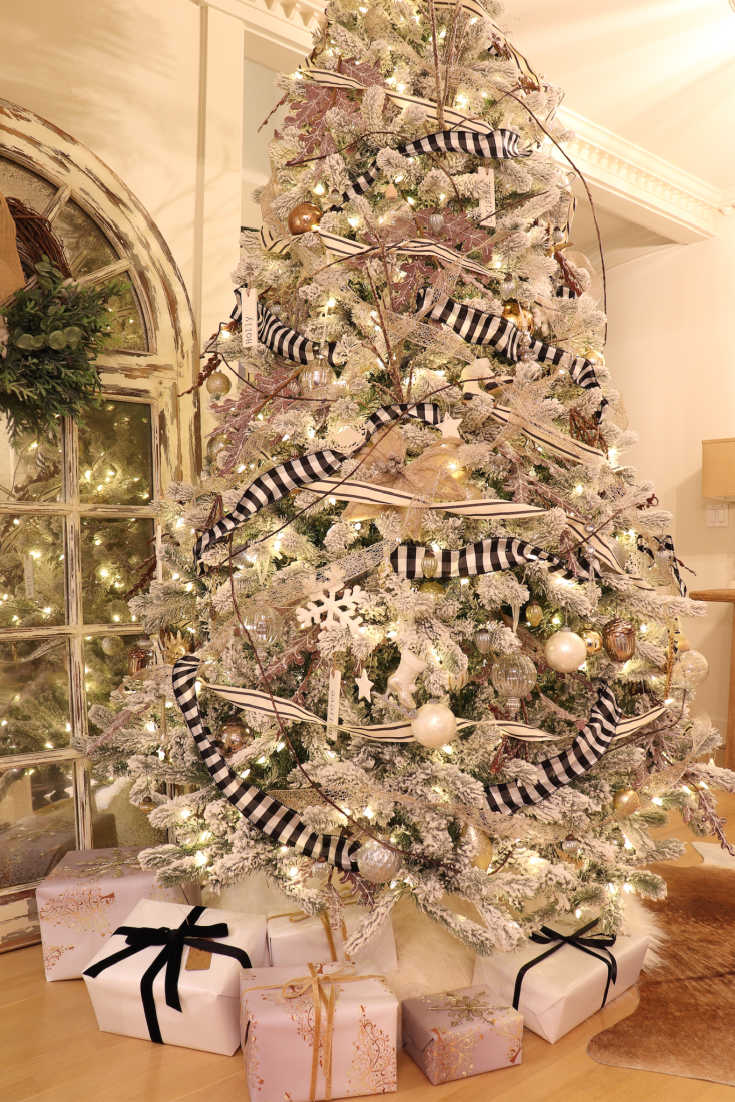 Flocked artificial tree is beautiful reflected in large farmhouse mirror