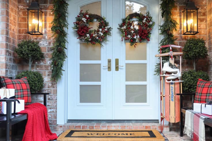 Christmas front porch decor with vintage sled and hand wrapped presents
