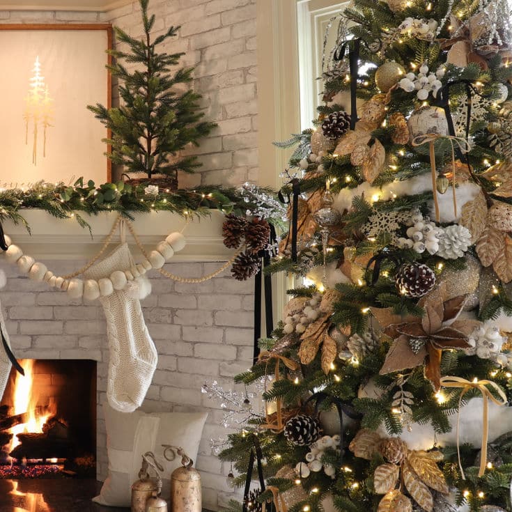 beautiful black and gold Christmas tree next to a white and gold fireplace mantel