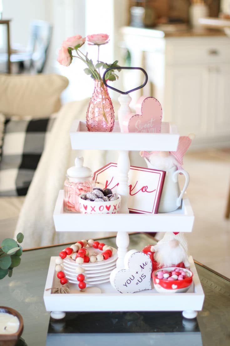 white wood 3 tiered tray filled with Valentines day decor and treats