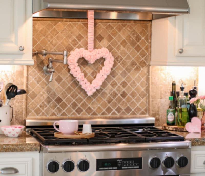 kitchen stainless steel stove with pink valentines day heart wreath hanging