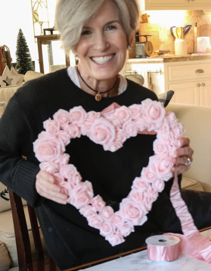 Showing my finished DIY pink Heart Valentines Day wreath I made