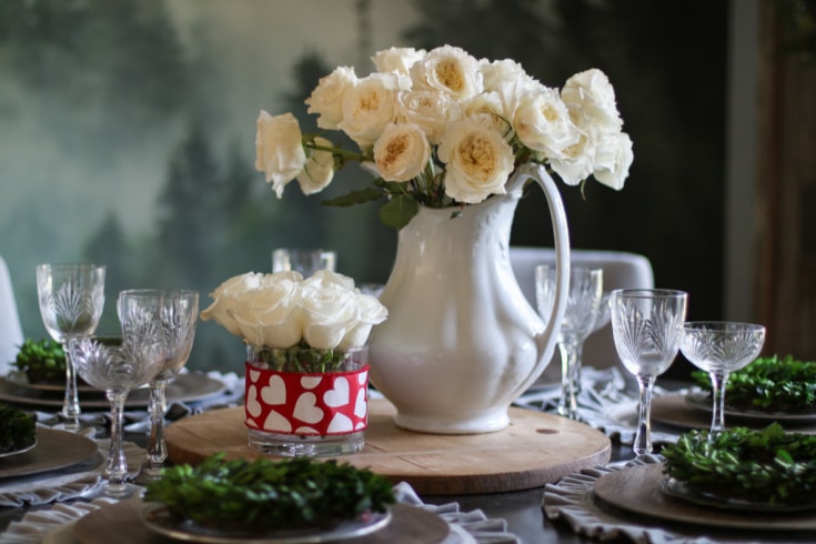 White roses in vintage ironstone pitcher and small Valentines day arrangement on dining room table