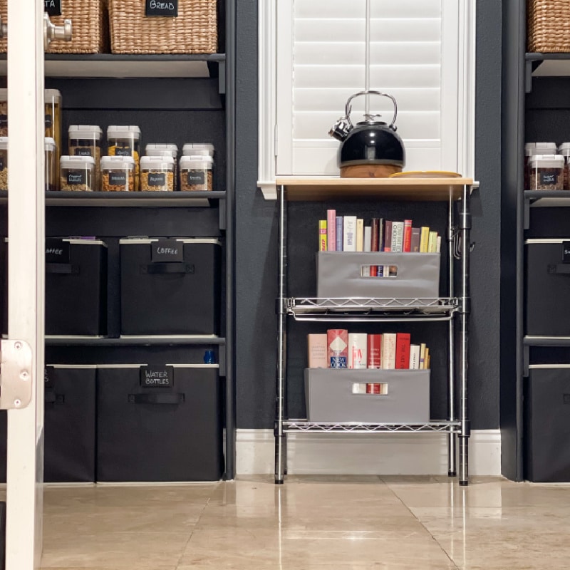 Monochromatic dark moody contrasting pantry with inexpensive labeled bins.