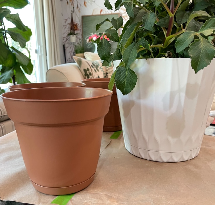 cheap plastic pots are inexpensive base for faux planters