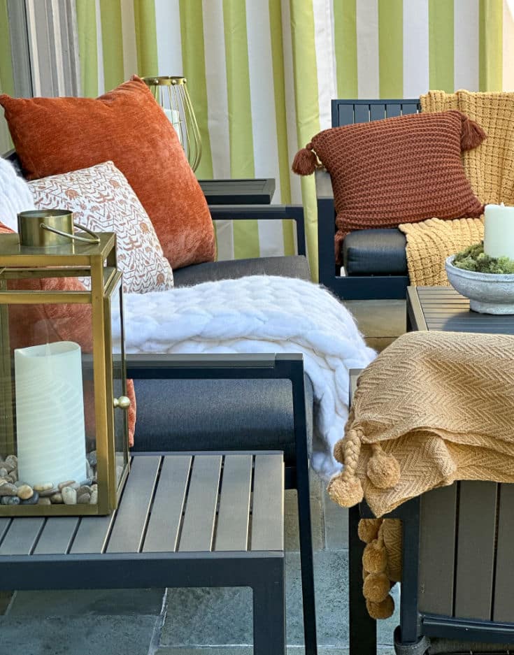 backyard patio furniture gets a fall makeover with cozy textiles and pillows