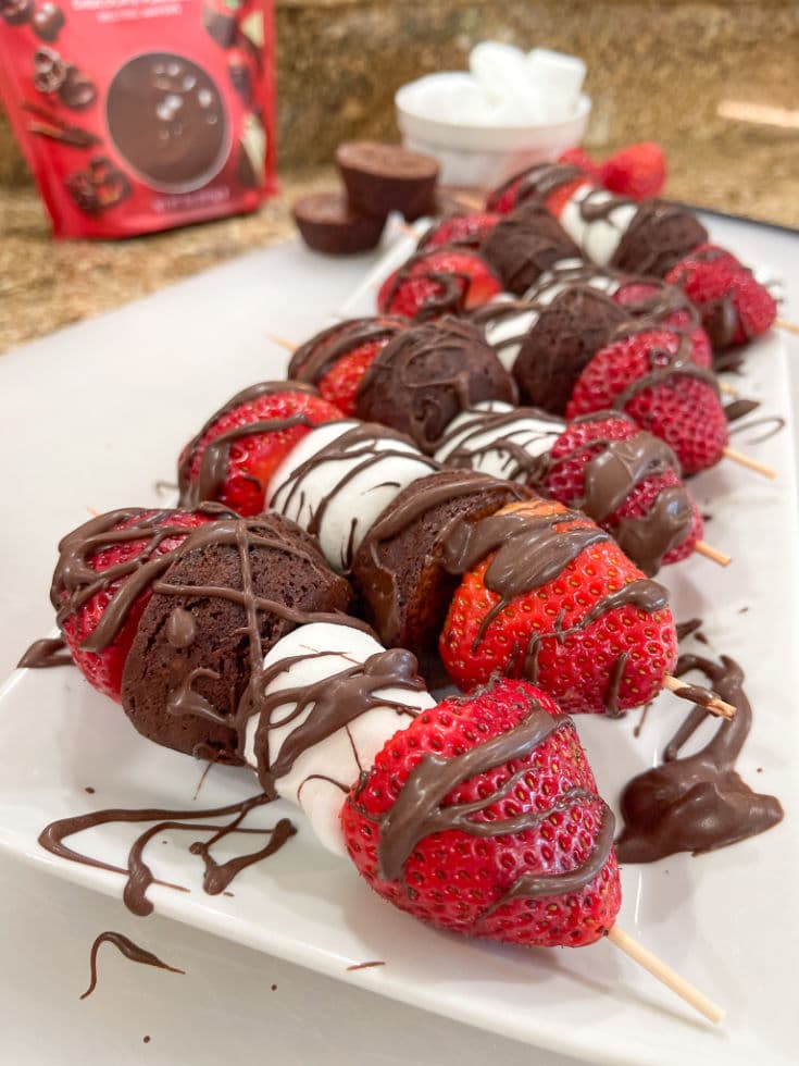 dessert kabobs with strawberries, marshmallows, mini brownie bites and finished with chocolate drizzle