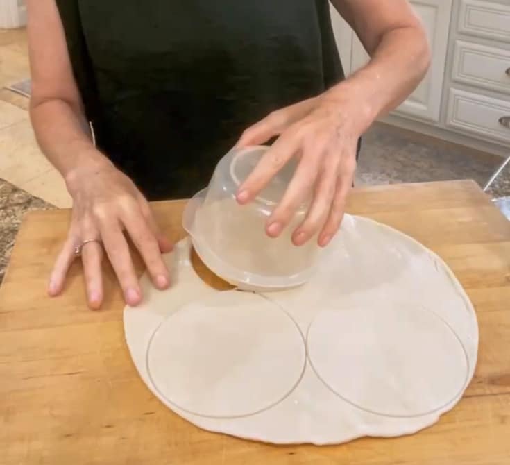 cutting small circles out of pie dough for mini pie crusts