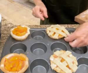 Mini peach pies topped with a lattice crust