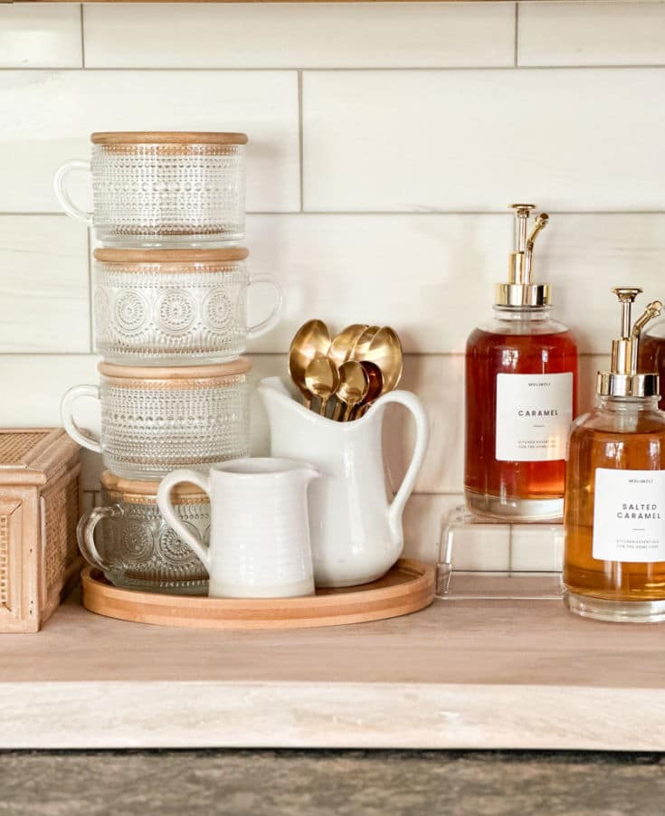 DIY Coffee bar supplies include flavored syrups, beautiful glassware and spoons