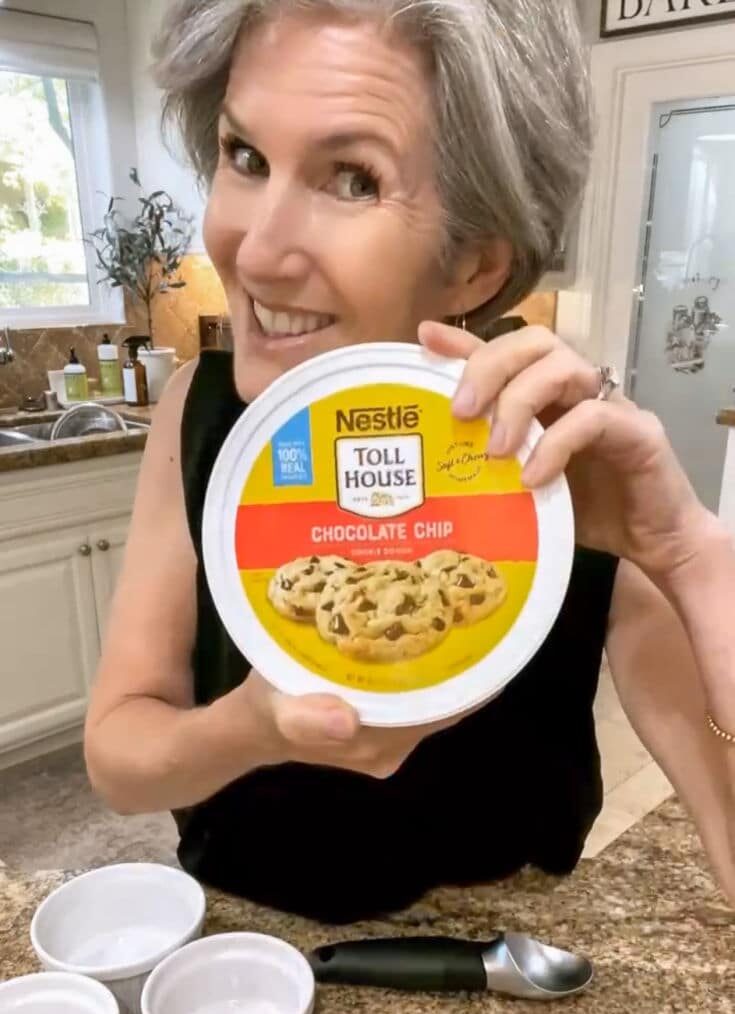 Jodie holding up a container of Toll House Chocolate Chip Cookie Dough, in preparation for Air Fryer chocolate chip cookies
