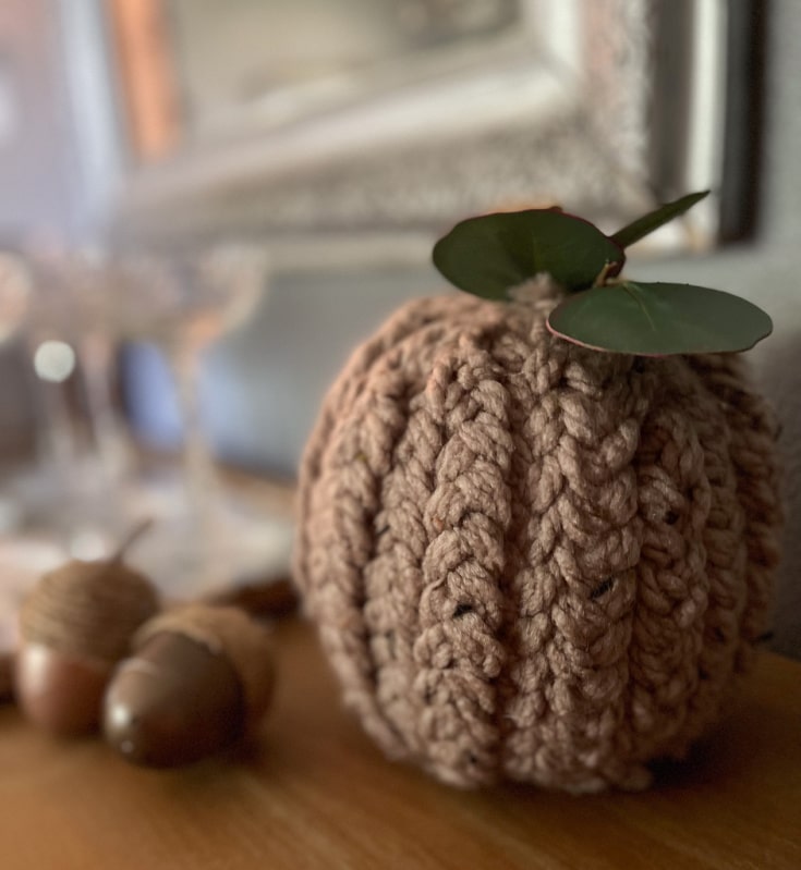 earthy brown yarn is braided and wrapped around a pumpkin, creating a beautiful texture to compliment your fall decor