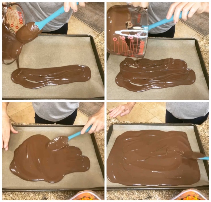 pouring milk chocolate onto a parchment lined baking sheet.Step one of how to make halloween bark
